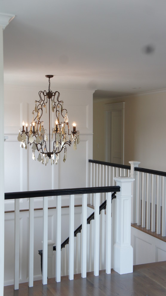Photo of a mid-sized transitional wood l-shaped staircase in Boston with wood risers and wood railing.