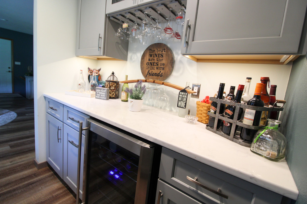 Inspiration for a galley home bar remodel with an undermount sink, shaker cabinets, quartz countertops and white countertops