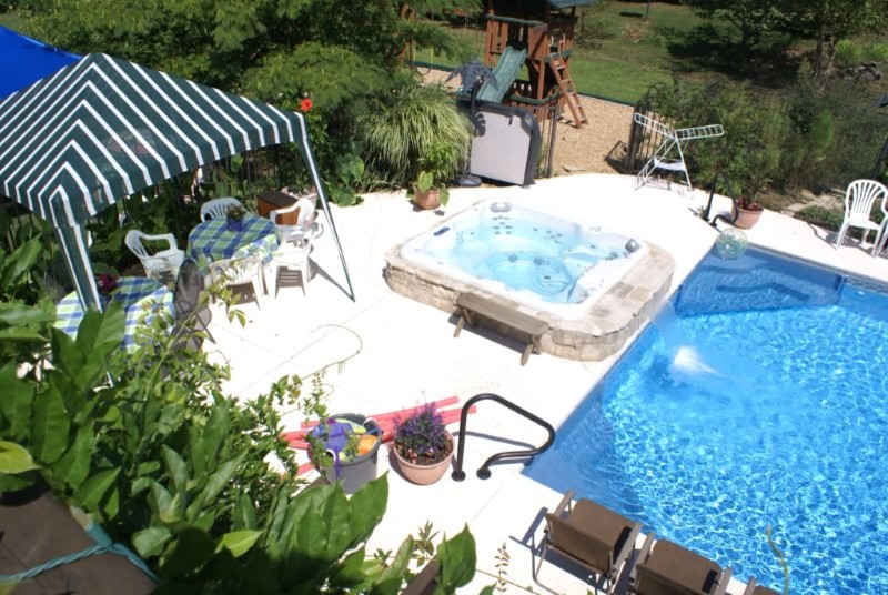 Mid-sized transitional backyard concrete and rectangular hot tub photo in St Louis