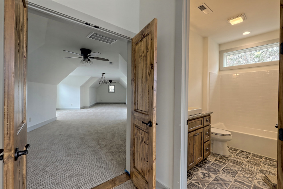 Example of a mid-sized cottage ceramic tile, multicolored floor and single-sink bathroom design in Atlanta with shaker cabinets, medium tone wood cabinets, a two-piece toilet, white walls, a vessel sink, granite countertops, multicolored countertops and a built-in vanity