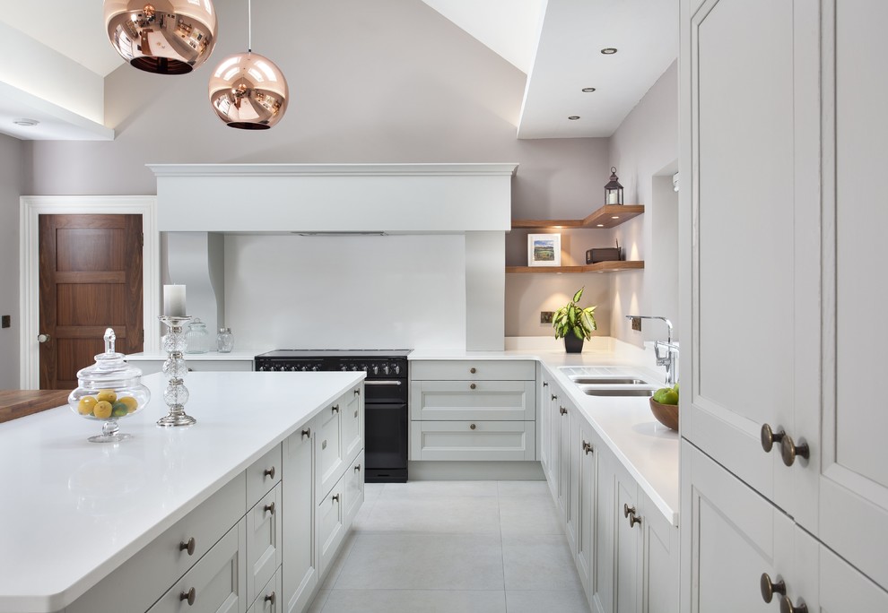 Transitional kitchen in Dublin with white cabinets, with island and white floor.