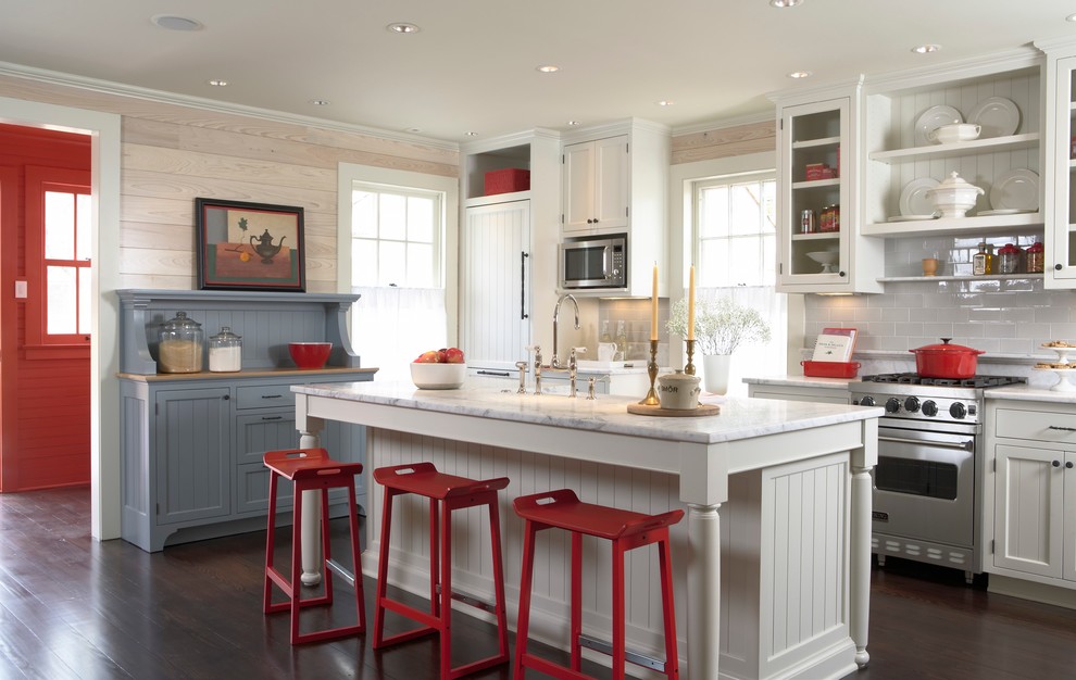 Inspiration for a traditional galley open plan kitchen in Minneapolis with a farmhouse sink, recessed-panel cabinets, white cabinets, marble benchtops, ceramic splashback, stainless steel appliances, dark hardwood floors and with island.