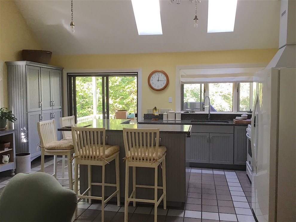 Example of a mid-sized transitional u-shaped ceramic tile and gray floor open concept kitchen design with an integrated sink, beaded inset cabinets, gray cabinets, quartz countertops, multicolored backsplash, stone slab backsplash, white appliances and an island