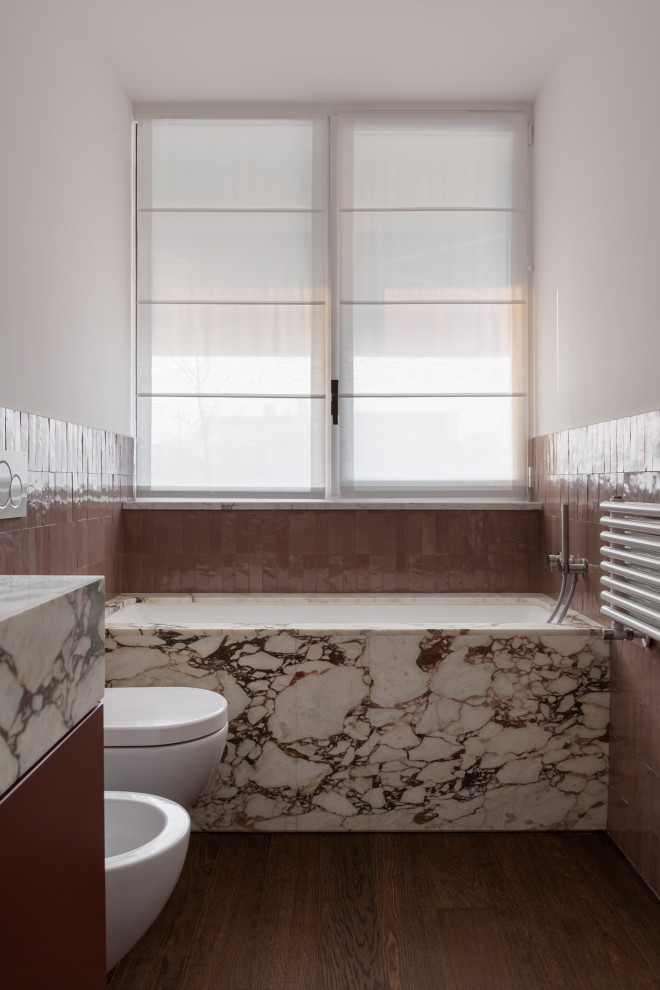 Mid-sized contemporary master bathroom in Milan with flat-panel cabinets, red cabinets, a drop-in tub, a two-piece toilet, white tile, terra-cotta tile, white walls, medium hardwood floors, a trough sink, marble benchtops, beige floor, an open shower, pink benchtops, a single vanity and a floating vanity.