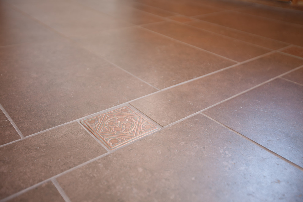 Foyer - mid-sized rustic porcelain tile and black floor foyer idea in Omaha with beige walls and a black front door