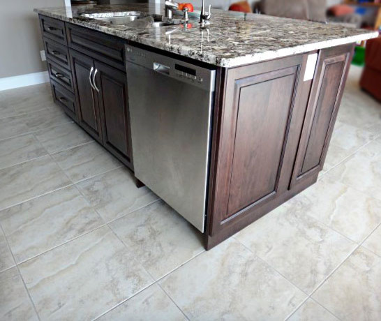 Kitchen - large transitional u-shaped porcelain tile kitchen idea in Toronto with raised-panel cabinets, dark wood cabinets, granite countertops and an island
