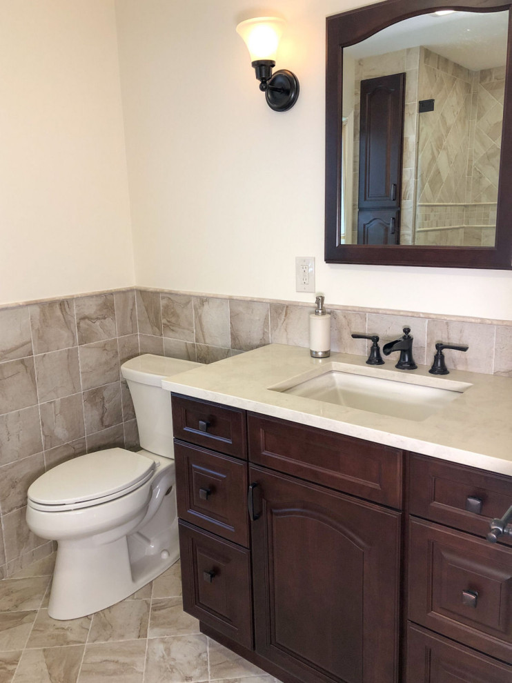 Transitional bathroom in Boston with an alcove shower, beige tile, ceramic tile, beige walls, ceramic floors, an undermount sink, beige floor, a hinged shower door, a niche and a single vanity.