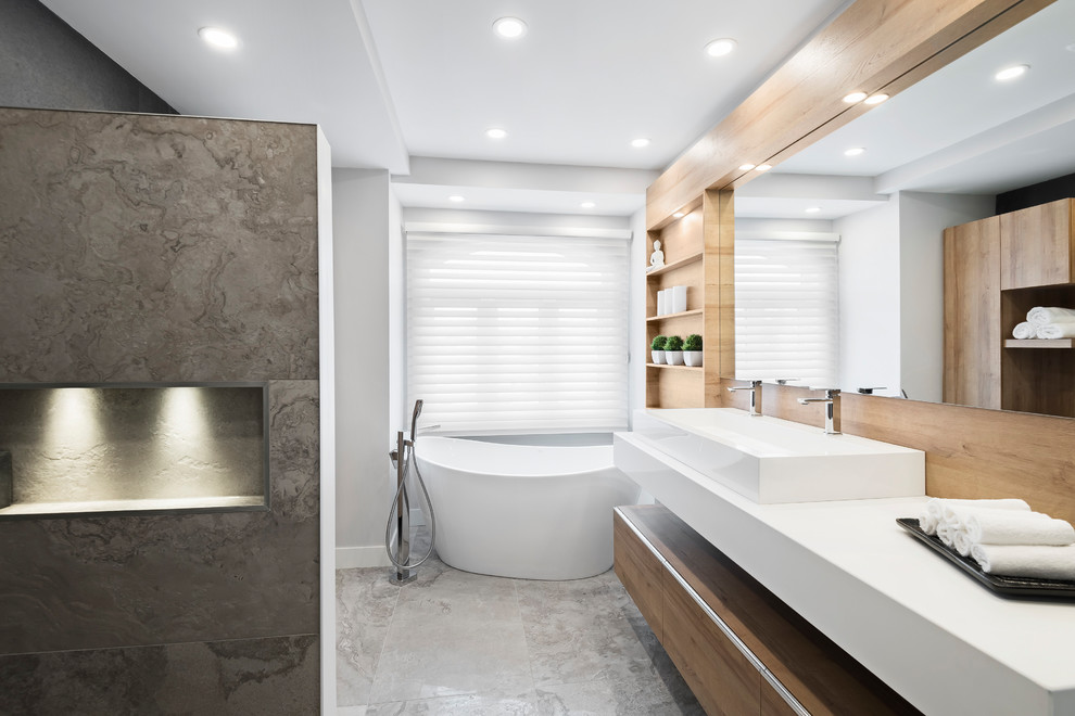 Inspiration for a mid-sized contemporary master bathroom in Montreal with flat-panel cabinets, beige cabinets, a freestanding tub, an alcove shower, a two-piece toilet, black tile, ceramic tile, beige walls, ceramic floors, a vessel sink, engineered quartz benchtops, beige floor, an open shower and white benchtops.