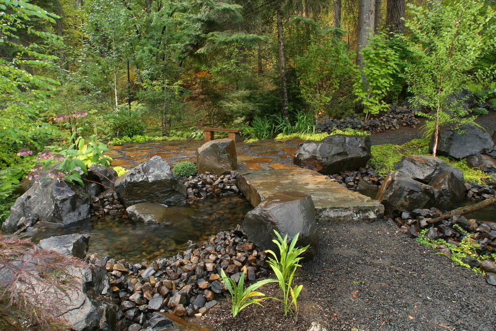 Photo of a large traditional backyard formal garden in Seattle with with pond.