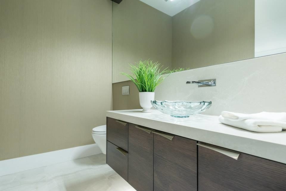 Design ideas for a contemporary powder room in Vancouver with engineered quartz benchtops, a vessel sink, flat-panel cabinets, dark wood cabinets, beige tile and beige walls.