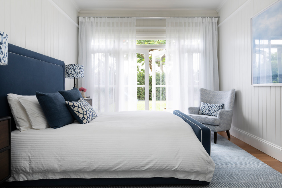 Inspiration for a large contemporary master bedroom in Brisbane with white walls and light hardwood floors.