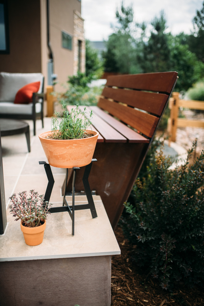 Patio - mid-sized contemporary backyard stone patio idea with a roof extension