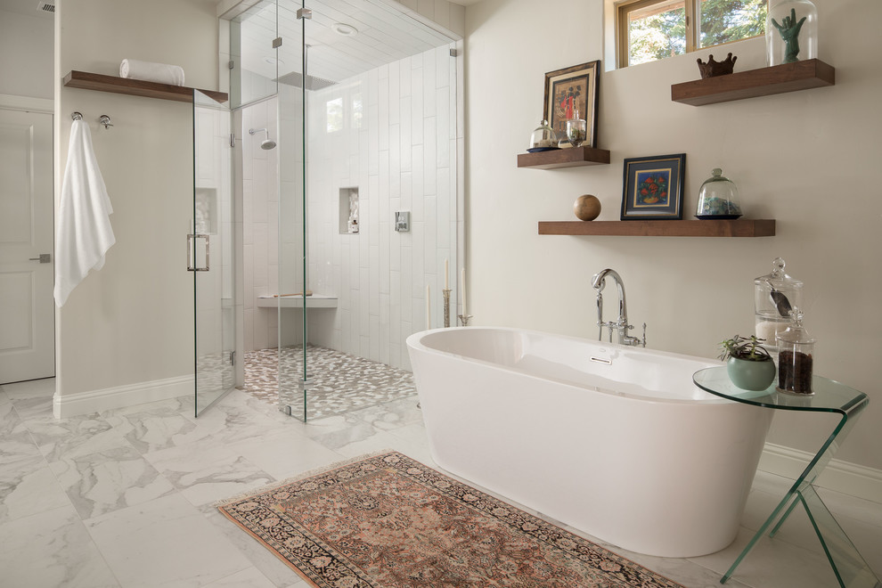Photo of a large modern master wet room bathroom in Sacramento with flat-panel cabinets, dark wood cabinets, a freestanding tub, white tile, ceramic tile, beige walls, marble floors, a vessel sink, white floor, a hinged shower door and white benchtops.