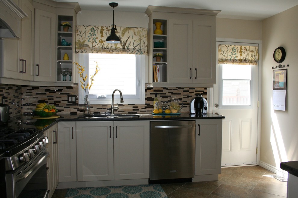 Example of a small transitional l-shaped enclosed kitchen design in Ottawa with an undermount sink, shaker cabinets, beige cabinets, granite countertops, glass sheet backsplash, stainless steel appliances and no island
