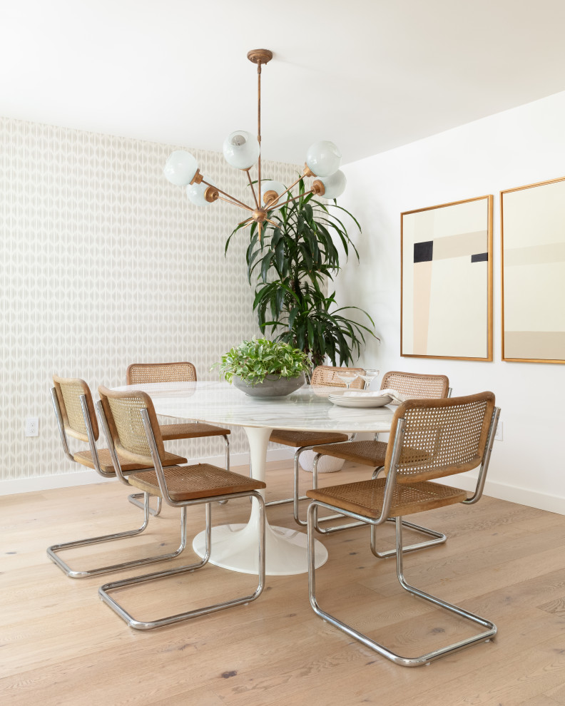 Example of a 1950s light wood floor kitchen/dining room combo design in Austin with white walls