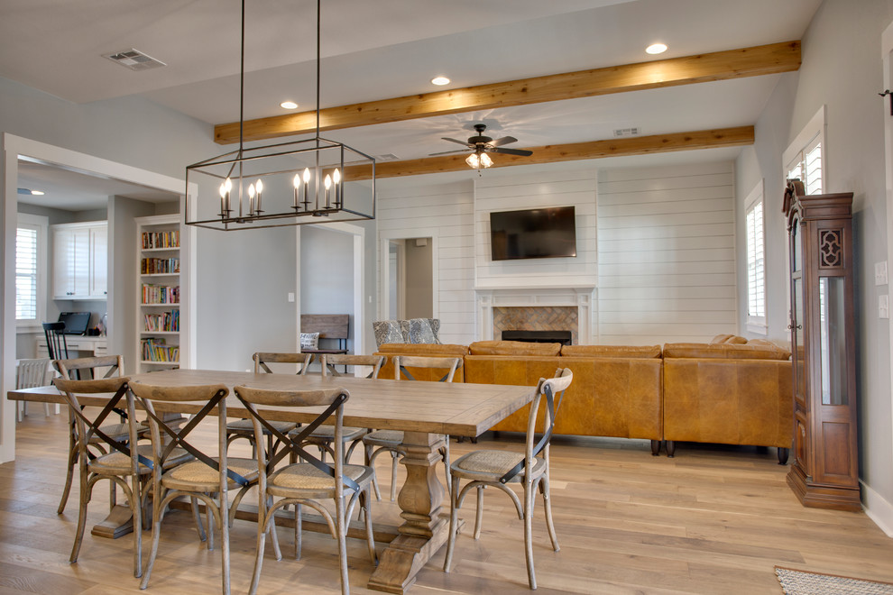 Country dining room in Austin with white walls, light hardwood floors and beige floor.