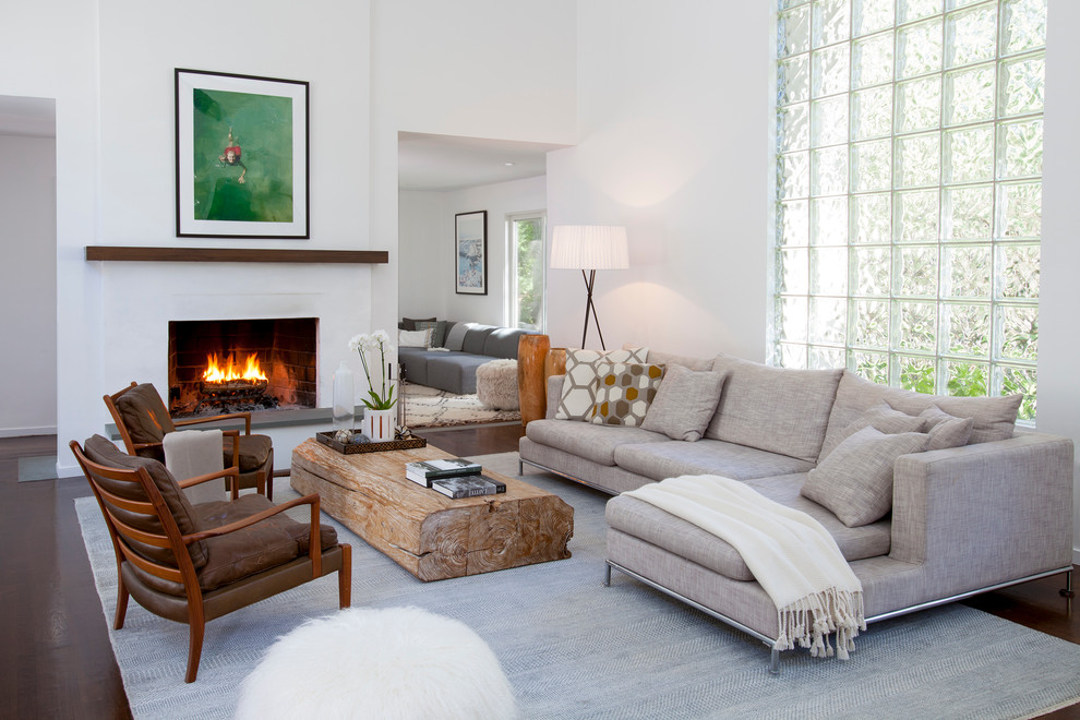 This is an example of a large contemporary formal open concept living room in New York with white walls, a standard fireplace and no tv.