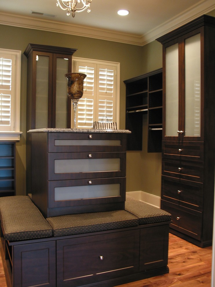 Photo of a large transitional walk-in wardrobe in Indianapolis with raised-panel cabinets and dark wood cabinets.