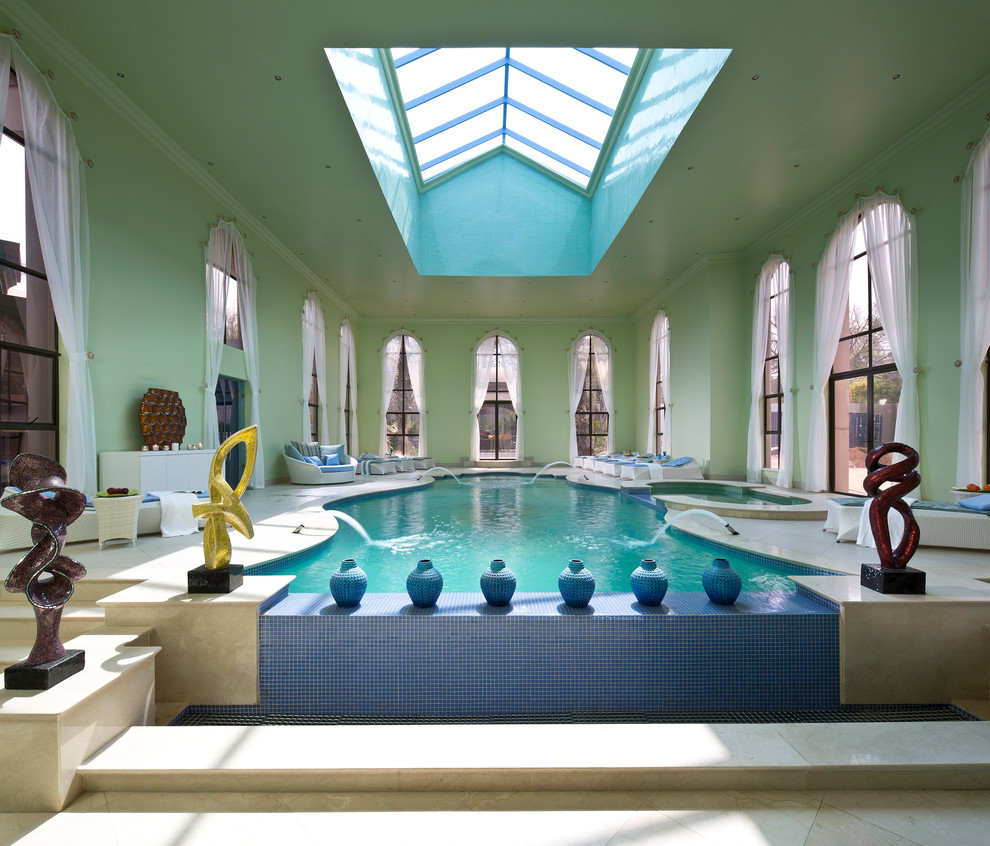 Photo of an expansive traditional indoor custom-shaped lap pool in Miami with a water feature and tile.