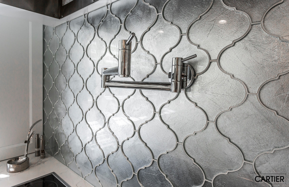 Eat-in kitchen - huge transitional l-shaped marble floor eat-in kitchen idea in Montreal with an undermount sink, shaker cabinets, white cabinets, quartzite countertops, gray backsplash, glass tile backsplash, paneled appliances and an island