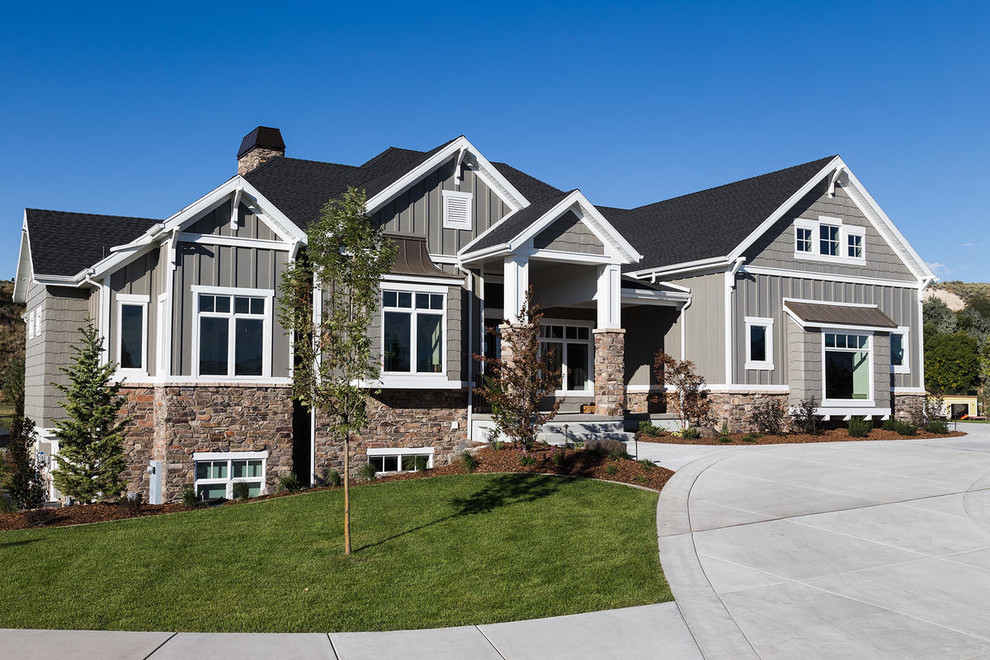 Photo of a large arts and crafts two-storey grey exterior in Salt Lake City with mixed siding and a gable roof.