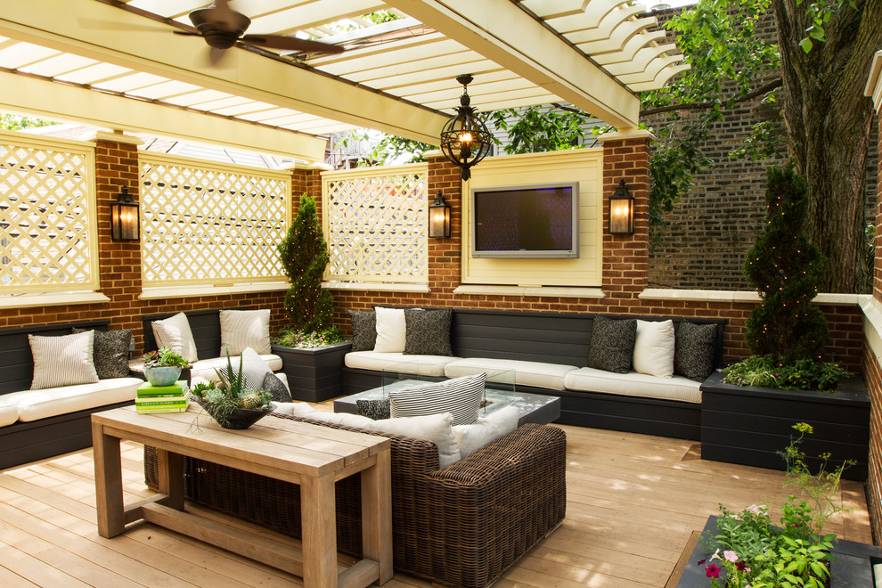 Large traditional backyard verandah in Chicago with a fire feature, decking and a pergola.