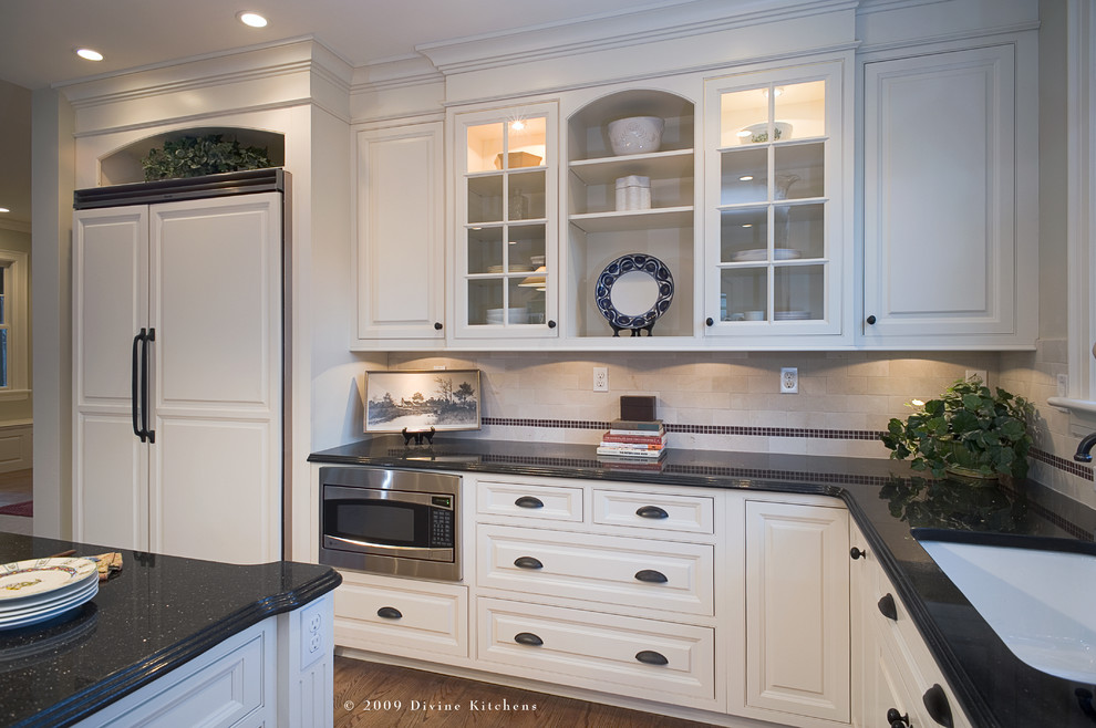 Design ideas for a large traditional l-shaped eat-in kitchen in Boston with an undermount sink, beaded inset cabinets, white cabinets, granite benchtops, white appliances, light hardwood floors and with island.