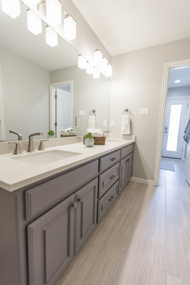 Inspiration for a medium sized classic family bathroom in Dallas with raised-panel cabinets, grey cabinets, an alcove shower, beige tiles, engineered stone worktops, white worktops, double sinks and a built in vanity unit.