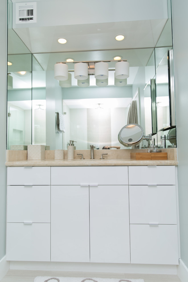 Design ideas for a mid-sized modern master bathroom in San Diego with an undermount sink, flat-panel cabinets, white cabinets, engineered quartz benchtops, light hardwood floors, brown tile, grey walls, an alcove shower, a one-piece toilet and a hinged shower door.