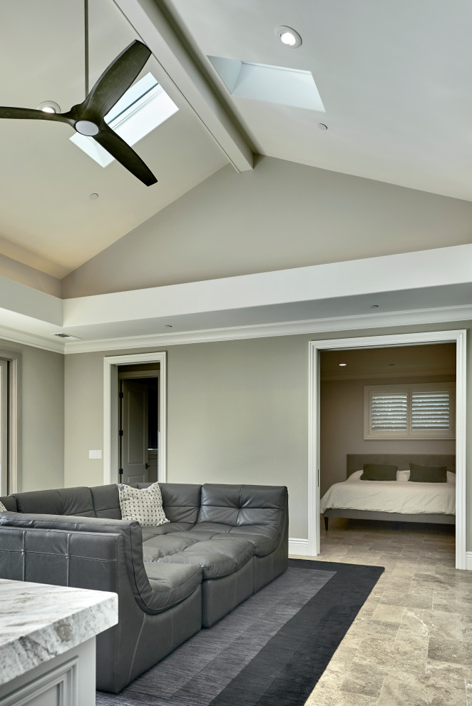 This is an example of a small traditional open plan games room in San Francisco with grey walls, limestone flooring, a wall mounted tv, brown floors and a drop ceiling.
