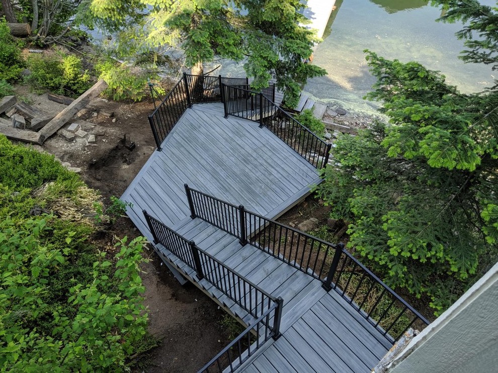 Example of a mid-sized classic backyard deck design in Seattle with no cover