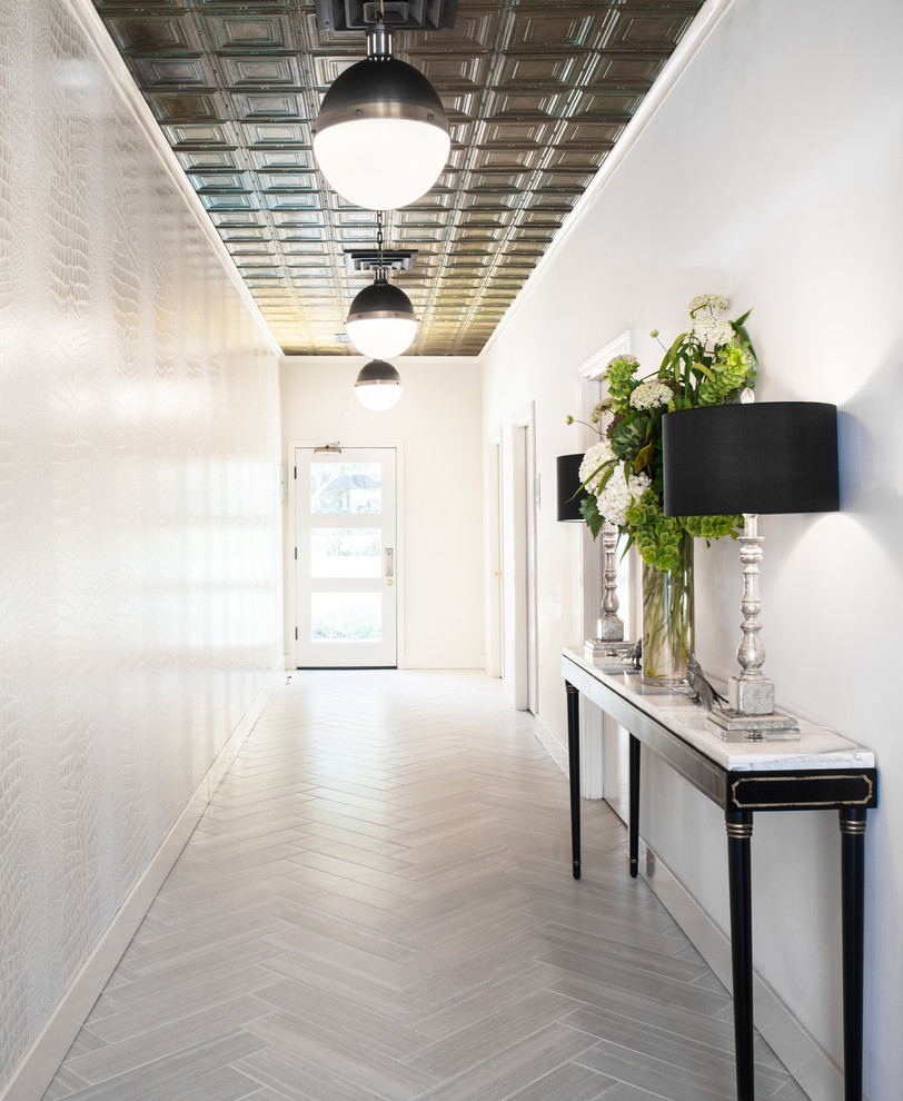 This is an example of a large transitional hallway in San Francisco with white walls, porcelain floors and grey floor.