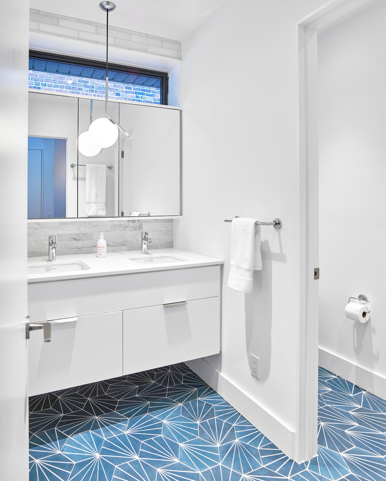 Photo of a contemporary bathroom in Toronto with flat-panel cabinets, white cabinets, an alcove shower, gray tile, marble, white walls, cement tiles, an undermount sink, engineered quartz benchtops, blue floor and white benchtops.