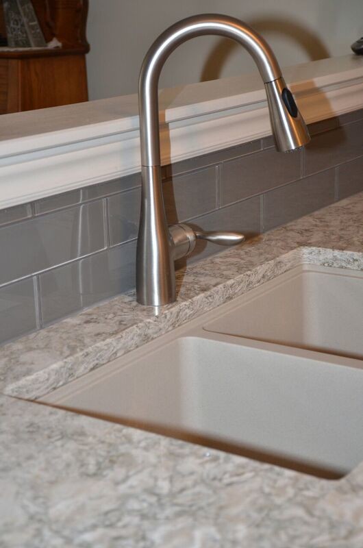 Inspiration for a mid-sized transitional u-shaped vinyl floor open concept kitchen remodel in Toronto with an undermount sink, raised-panel cabinets, white cabinets, quartzite countertops, gray backsplash, glass tile backsplash, white appliances and a peninsula