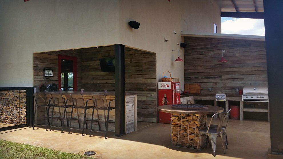 Patio - rustic concrete patio idea in Austin with a roof extension