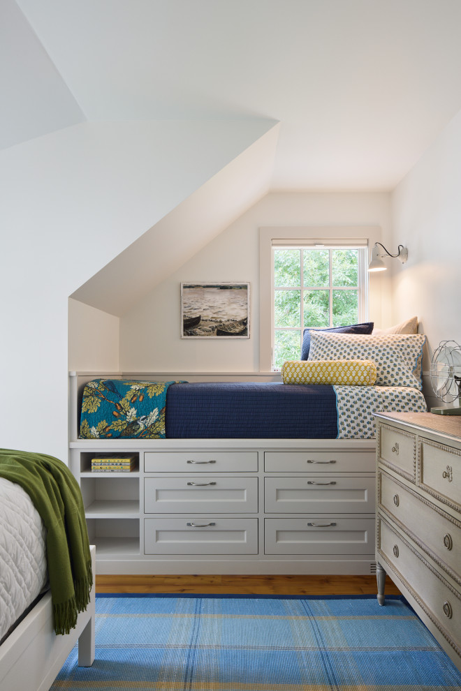 Example of a bedroom beach style gender-neutral kids' bedroom design in Minneapolis with white walls