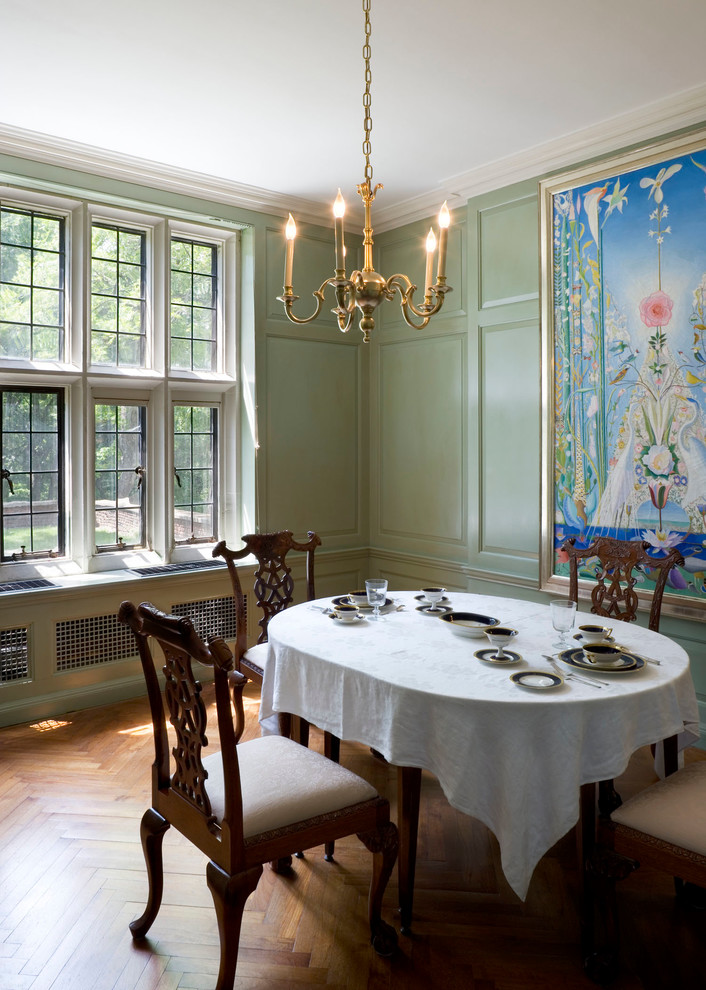 Inspiration for a traditional dining room in Other with green walls and medium hardwood floors.