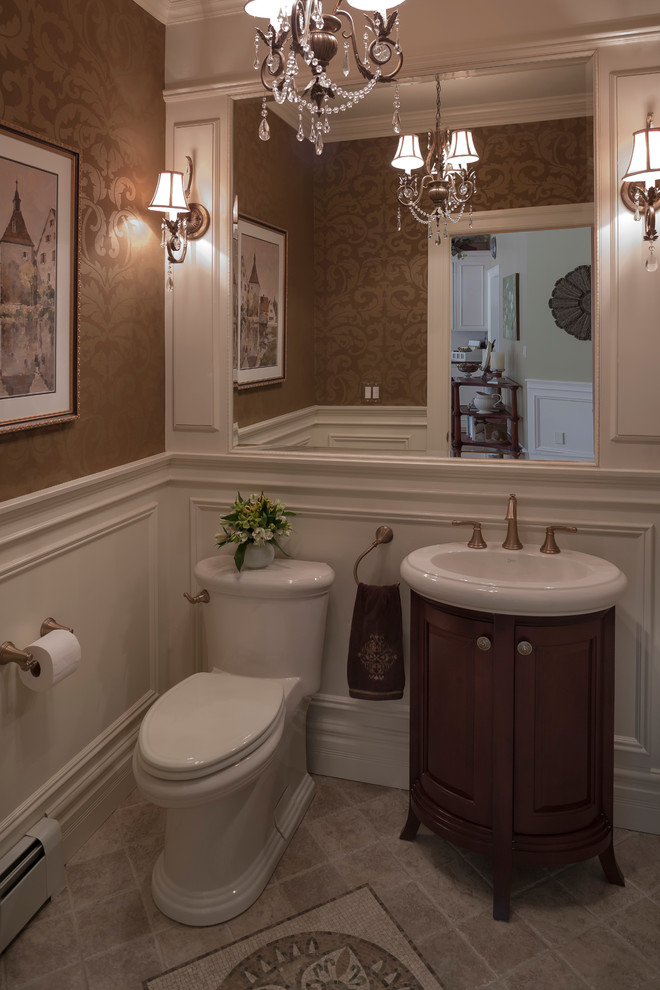 Design ideas for a small traditional powder room in New York with recessed-panel cabinets, dark wood cabinets, a one-piece toilet, beige tile, brown walls, porcelain floors and an integrated sink.