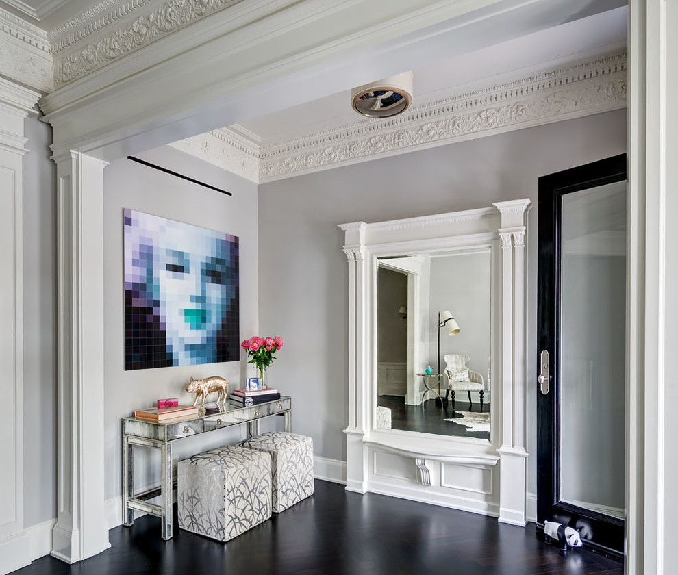 This is an example of a transitional foyer in New York with grey walls, dark hardwood floors, a single front door, a glass front door and black floor.
