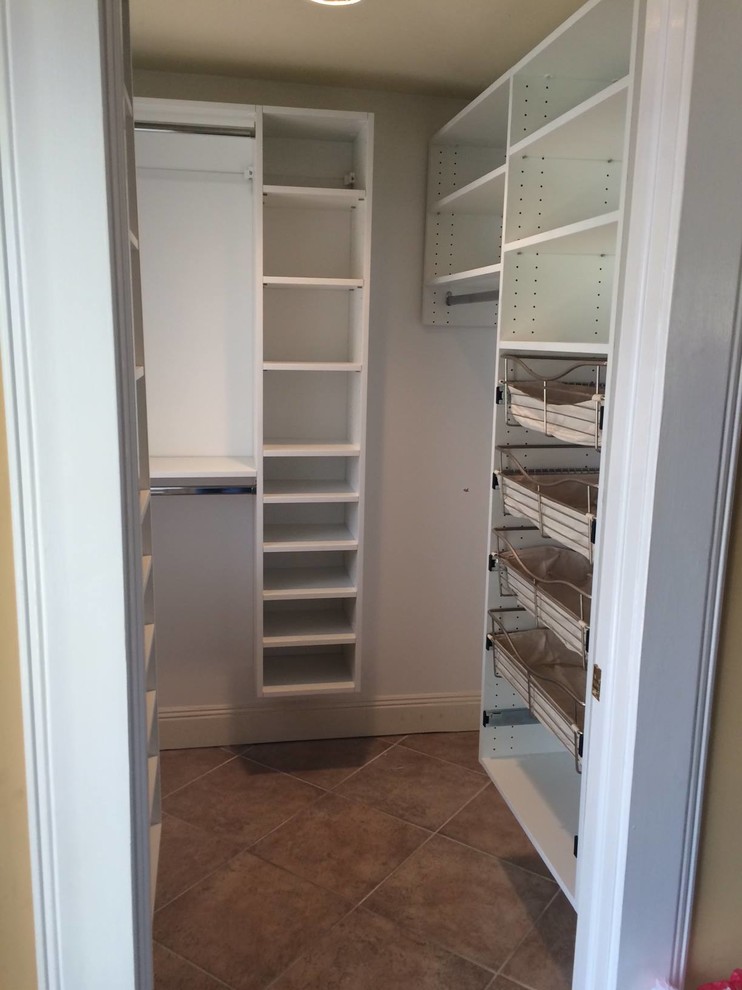 Inspiration for a large traditional gender-neutral walk-in wardrobe in New York with open cabinets, white cabinets and ceramic floors.