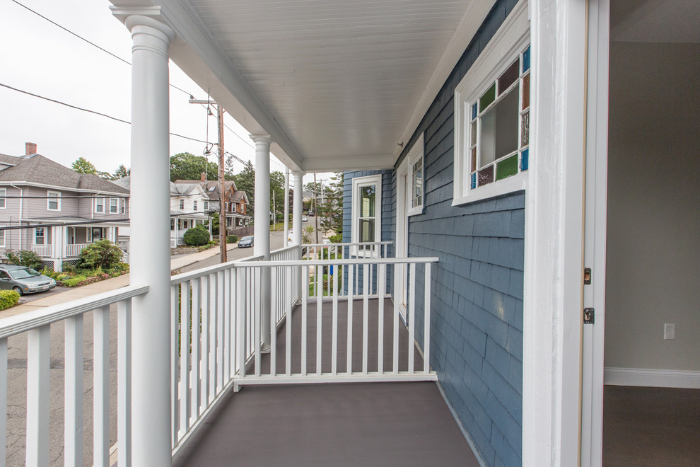 Example of a mid-sized transitional blue two-story wood townhouse exterior design in Boston with a shingle roof