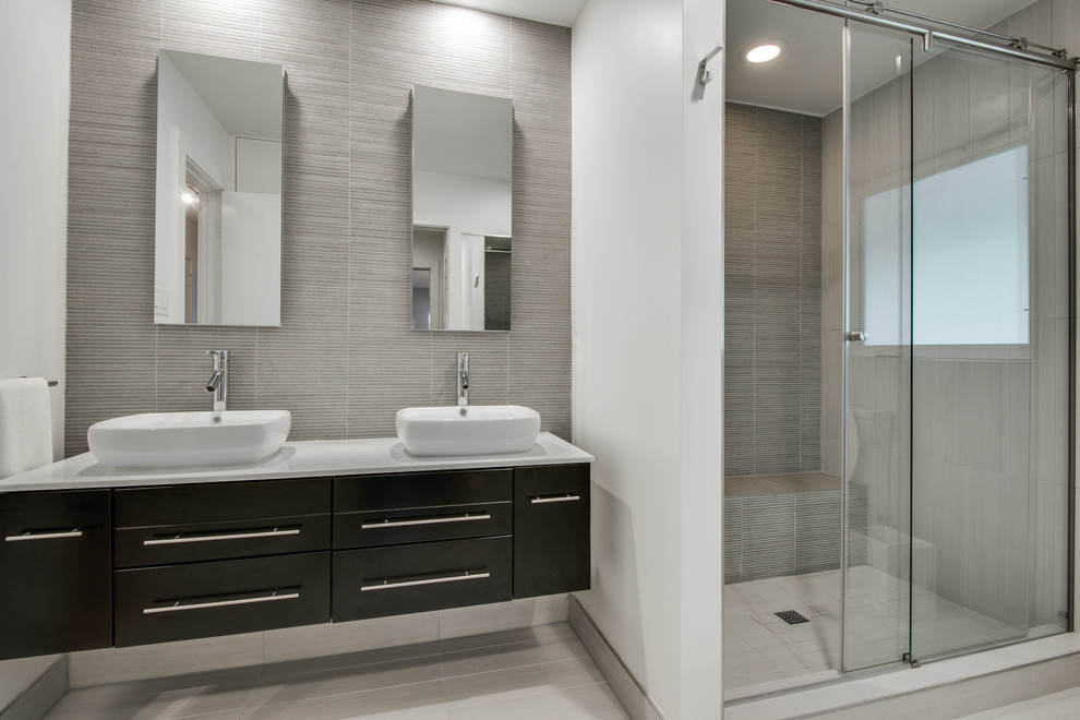 Design ideas for a large scandinavian master bathroom in Dallas with flat-panel cabinets, dark wood cabinets, a corner shower, gray tile, mosaic tile, white walls, ceramic floors, a vessel sink and engineered quartz benchtops.