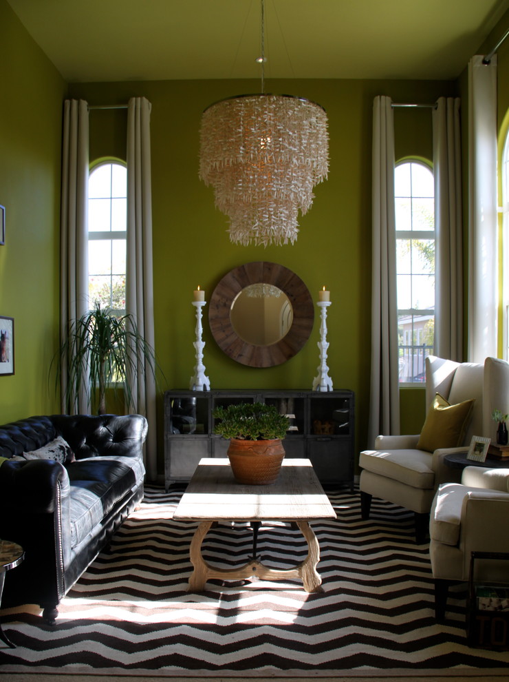 This is an example of an eclectic living room in Orange County with green walls.
