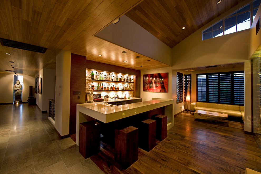 Photo of a contemporary galley home bar in Las Vegas with dark hardwood floors.