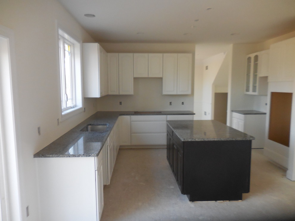 Kitchen - transitional kitchen idea in Baltimore with raised-panel cabinets and an island