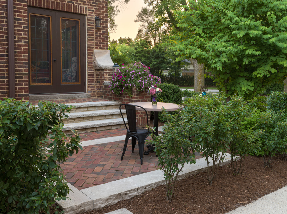 Inspiration for a small transitional side yard patio in Milwaukee with a vegetable garden, brick pavers and no cover.