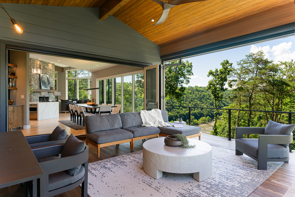 Trendy cable railing porch photo in Other with a roof extension and decking