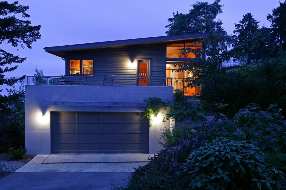 This is an example of a mid-sized contemporary two-storey grey exterior in Seattle with wood siding.