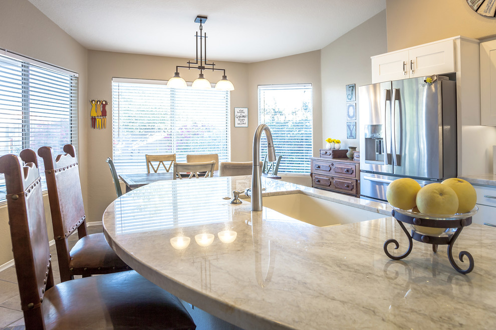 Inspiration for a transitional galley ceramic tile open concept kitchen remodel in Phoenix with an undermount sink, recessed-panel cabinets, white cabinets, quartz countertops, white backsplash, ceramic backsplash, stainless steel appliances and an island