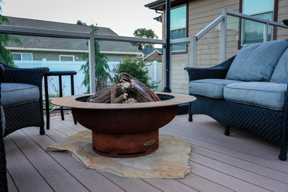 Design ideas for a small asian backyard deck in Seattle with a fire feature and no cover.